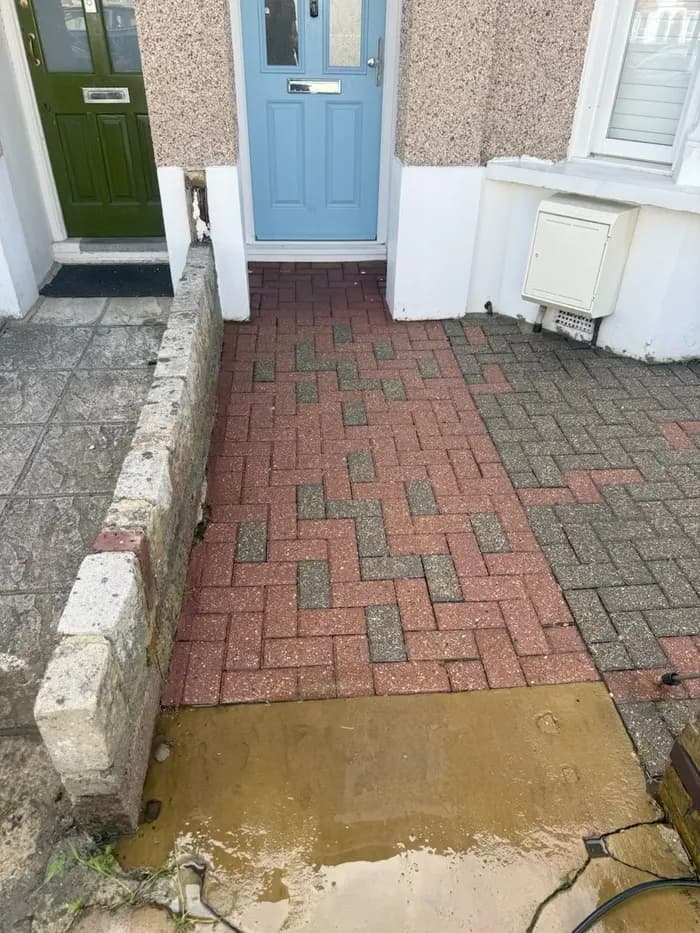 Same front doorstep block paving fully restored and weed-free after pressure washing